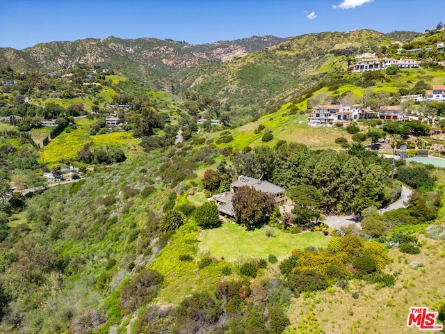 birds eye view of property with a mountain view