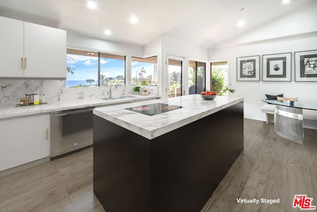 kitchen with white cabinets, a kitchen island, stainless steel dishwasher, black electric cooktop, and sink