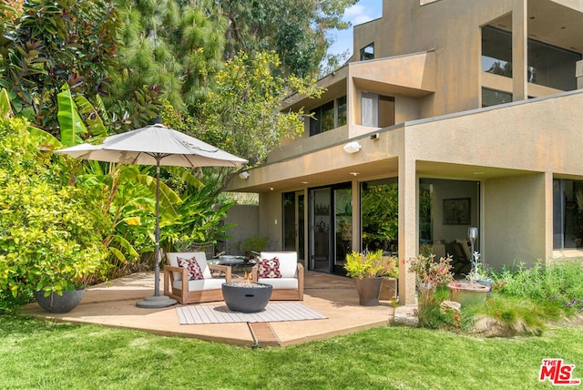 rear view of property with a patio area and a yard