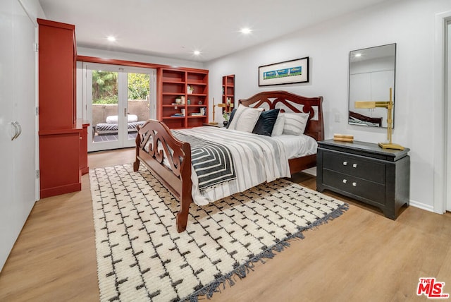 bedroom featuring french doors, access to outside, and light hardwood / wood-style flooring