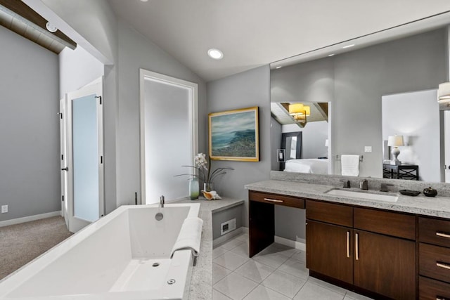 bathroom with tile patterned flooring, vanity, vaulted ceiling, and a bath