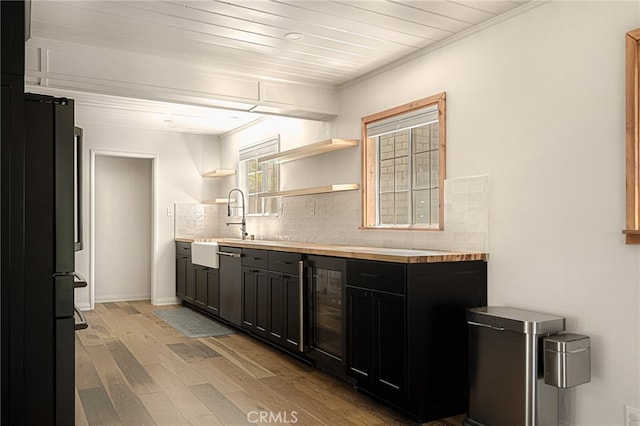 kitchen featuring wine cooler, stainless steel dishwasher, refrigerator, light hardwood / wood-style floors, and decorative backsplash