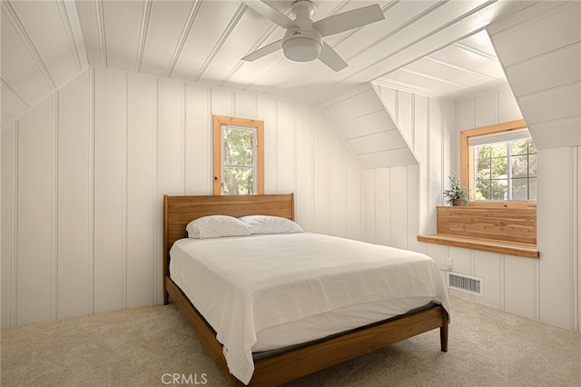 bedroom with carpet, vaulted ceiling, and ceiling fan