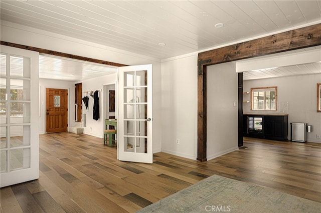 interior space with french doors, a wealth of natural light, wooden ceiling, and dark wood-type flooring