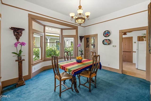 dining area with carpet and a chandelier