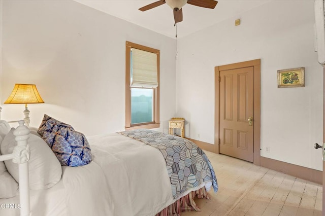 bedroom with ceiling fan and light hardwood / wood-style floors