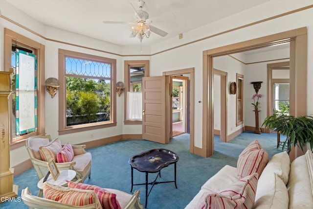 carpeted living room with ceiling fan