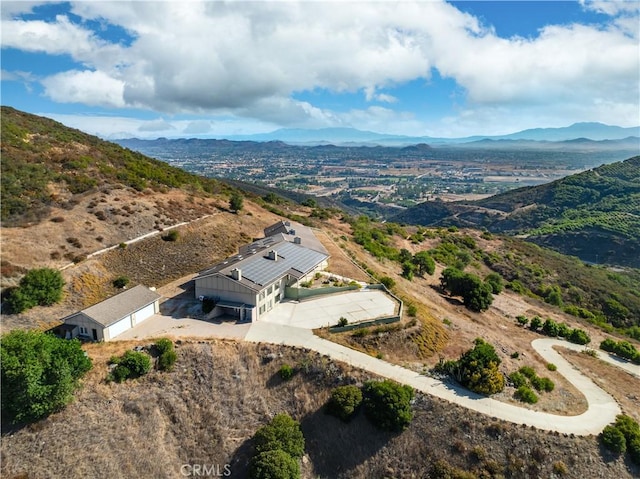 birds eye view of property featuring a mountain view