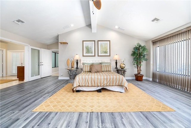 bedroom featuring french doors, wood-type flooring, lofted ceiling with beams, and ceiling fan