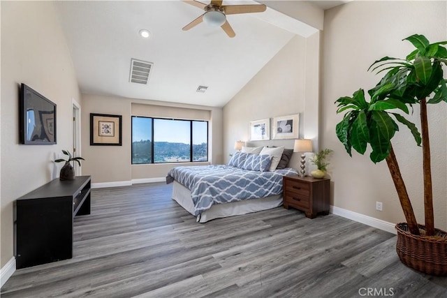 bedroom featuring wood-type flooring, high vaulted ceiling, and ceiling fan