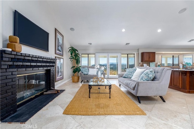 living room featuring a brick fireplace