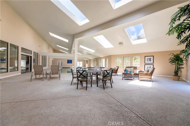 dining space with carpet, beam ceiling, and high vaulted ceiling