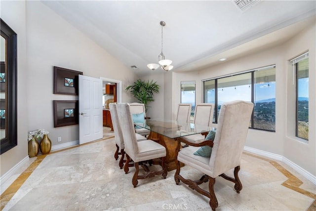 dining space with a chandelier and lofted ceiling