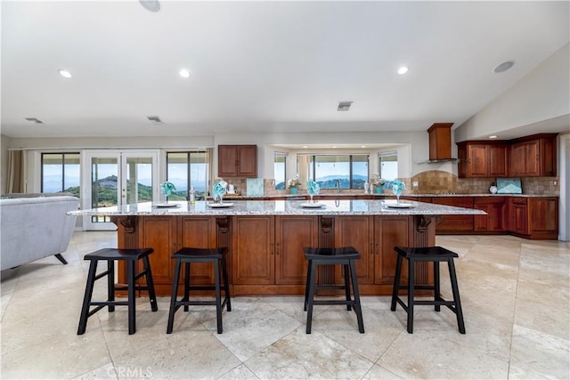 kitchen with plenty of natural light, a kitchen breakfast bar, and decorative backsplash