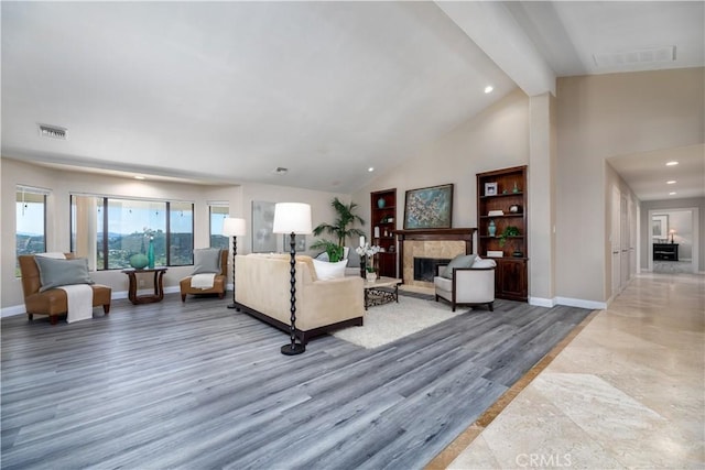 living room featuring beamed ceiling, hardwood / wood-style floors, and high vaulted ceiling