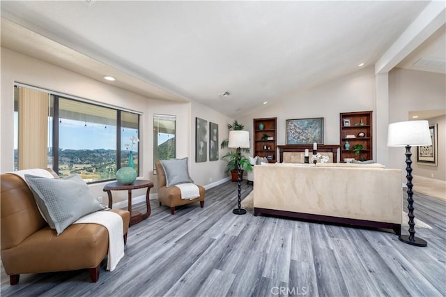 living room with lofted ceiling and hardwood / wood-style flooring