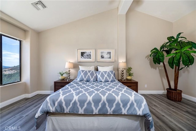 bedroom featuring wood-type flooring and vaulted ceiling