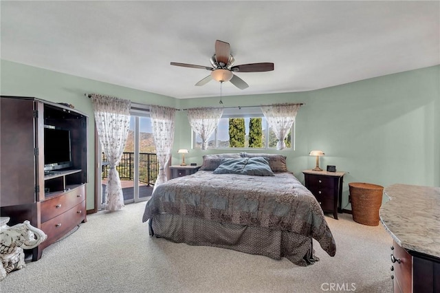 carpeted bedroom featuring ceiling fan, access to outside, and multiple windows