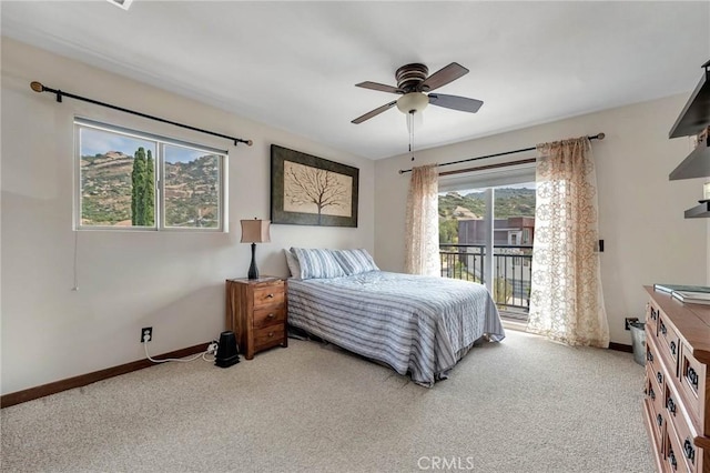 bedroom with access to exterior, ceiling fan, and light colored carpet