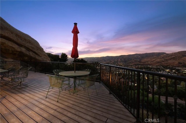 deck at dusk with a mountain view