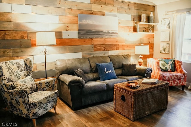 living room with wood walls and hardwood / wood-style flooring