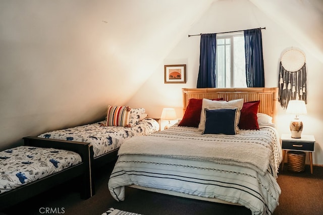 carpeted bedroom featuring lofted ceiling