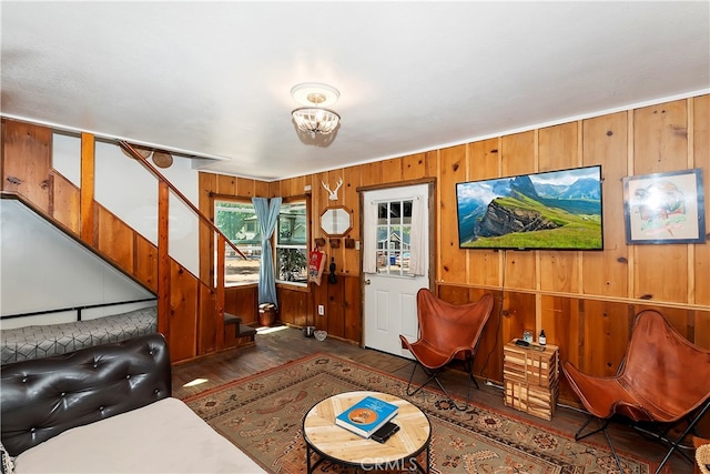 living room with wooden walls and dark hardwood / wood-style flooring