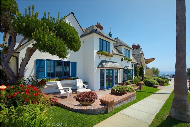 rear view of house with french doors and a patio area