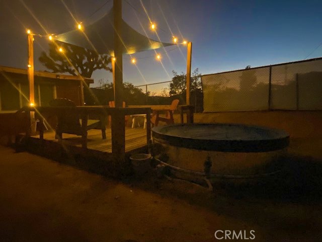 yard at dusk with a swimming pool side deck