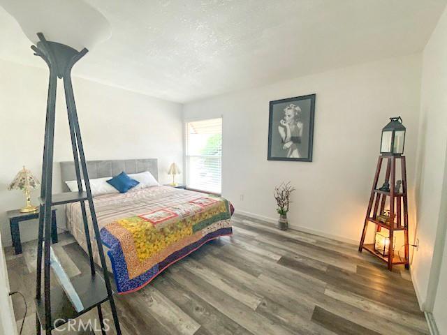 61974 Terrace Dr, Joshua Tree, CA 92252 - bedroom featuring wood finished floors and baseboards