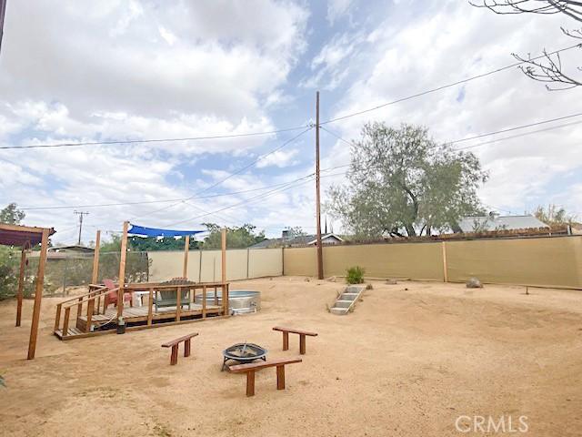61974 Terrace Dr, Joshua Tree, CA 92252 - view of jungle gym with an outdoor fire pit and a deck