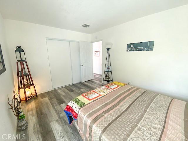 61974 Terrace Dr, Joshua Tree, CA 92252 - bedroom with wood finished floors and a closet