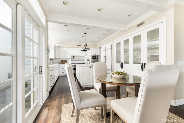 dining space with ornamental molding and dark wood-type flooring