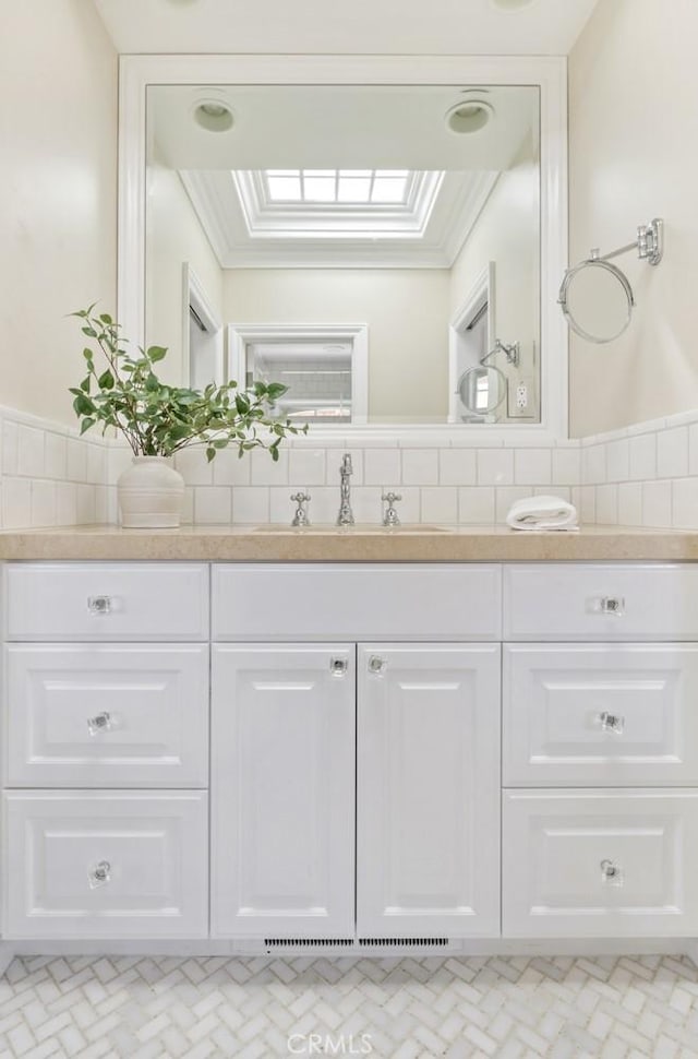 bathroom with vanity and tasteful backsplash