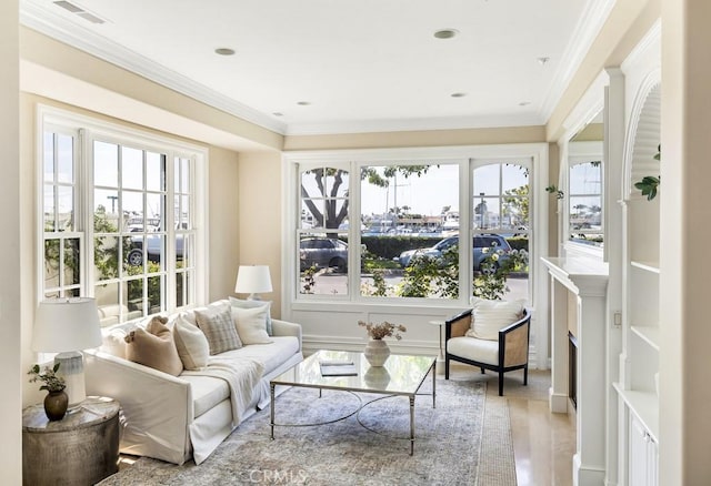 interior space with light hardwood / wood-style floors and ornamental molding