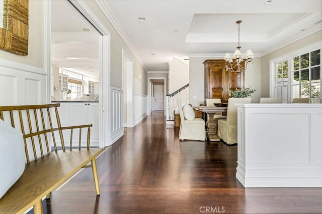 dining space featuring dark hardwood / wood-style flooring, plenty of natural light, a chandelier, and ornamental molding