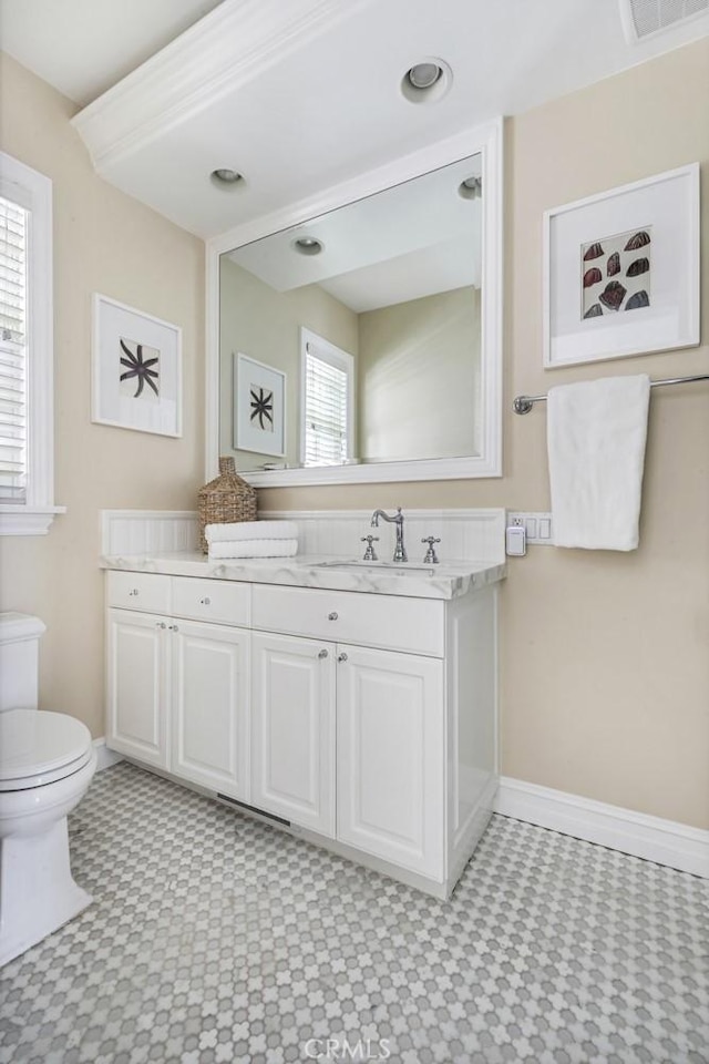 bathroom featuring vanity and toilet