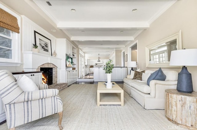 living room with beam ceiling, crown molding, and a brick fireplace