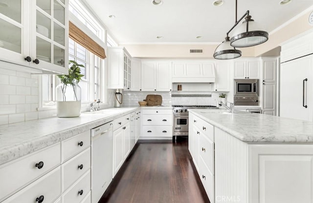 kitchen featuring white cabinets, appliances with stainless steel finishes, light stone counters, and hanging light fixtures