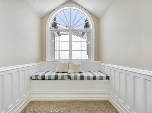 unfurnished room with vaulted ceiling