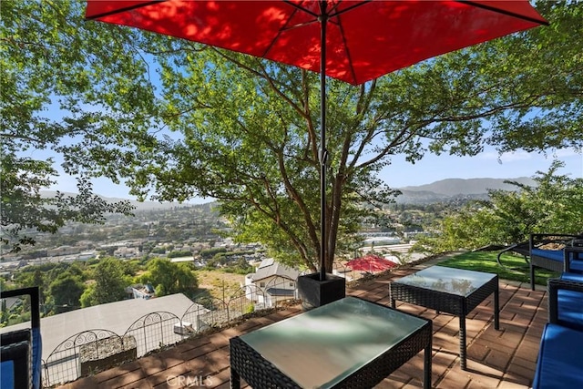 wooden deck featuring a mountain view and an outdoor hangout area