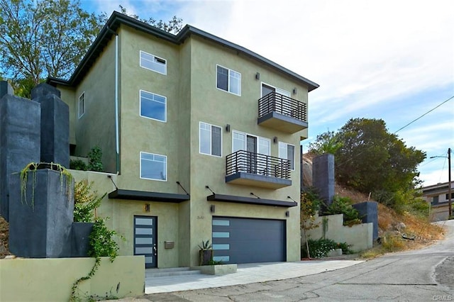 view of front facade with a garage and a balcony