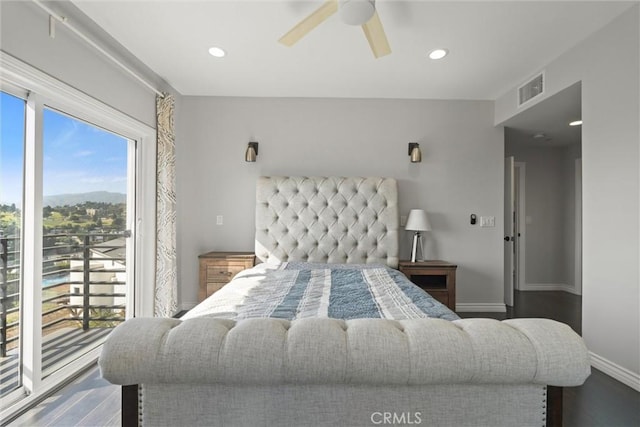 bedroom featuring multiple windows, hardwood / wood-style floors, access to exterior, and ceiling fan