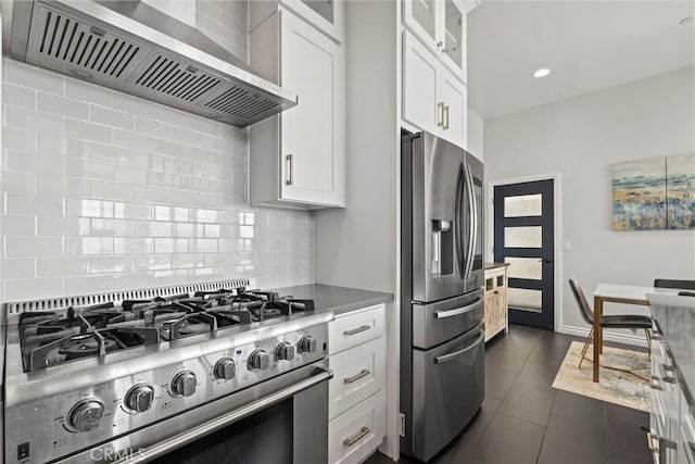 kitchen featuring white cabinetry, appliances with stainless steel finishes, and wall chimney exhaust hood