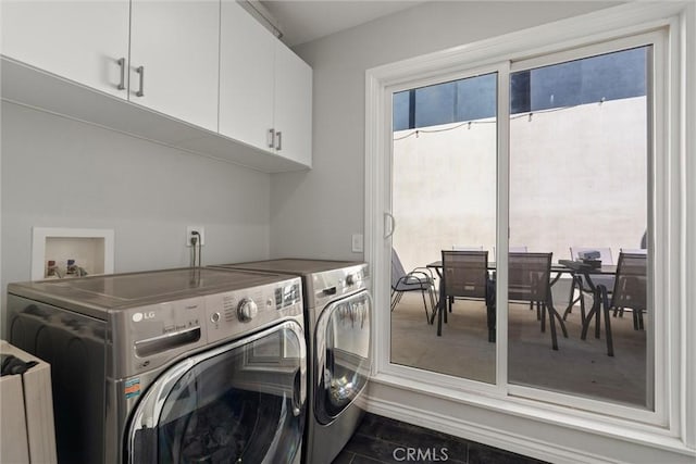 laundry room with cabinets, plenty of natural light, and washing machine and clothes dryer