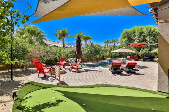 view of patio / terrace with a swimming pool with hot tub