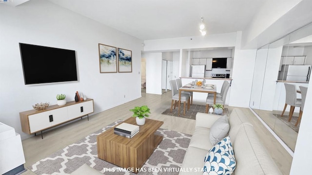 living room with light hardwood / wood-style flooring