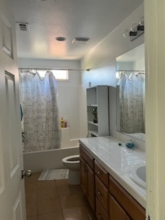 full bathroom with shower / bathtub combination with curtain, tile patterned flooring, vanity, and toilet