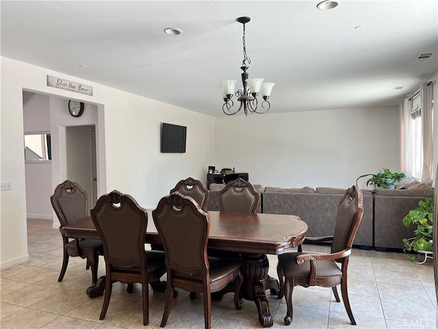 dining area featuring light tile patterned floors and a chandelier