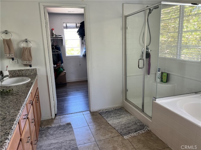 bathroom with tile patterned floors, independent shower and bath, and vanity